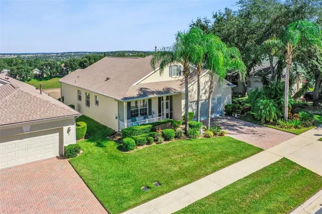 a aerial view of a house with a yard table and chairs