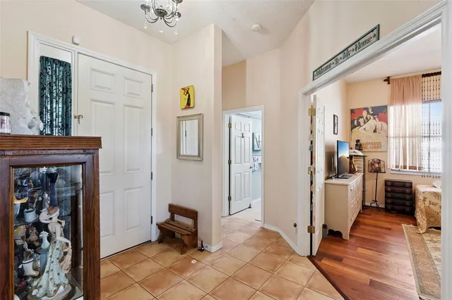 a view of a hallway with dining area and windows