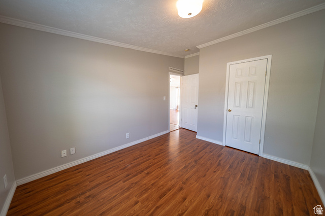 1407 North 1250th Street West Helper, UT 84526 - Photo 15 of 27 Bedroom 2 featuring a textured ceiling, dark wood-style floors, and ornamental molding