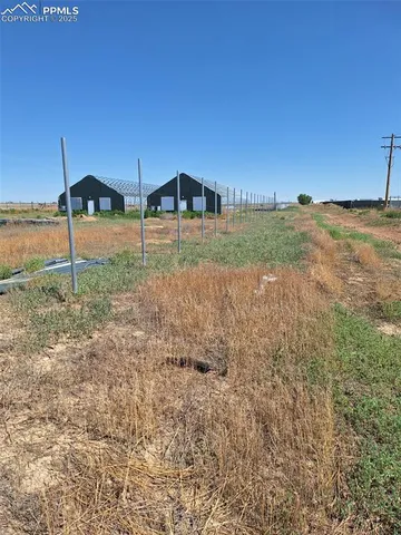 a room with water heater and wooden cabinets