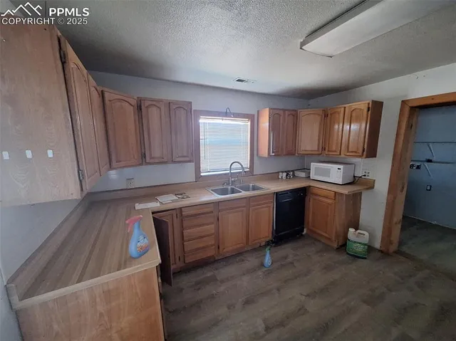 a kitchen with a sink stove and cabinets