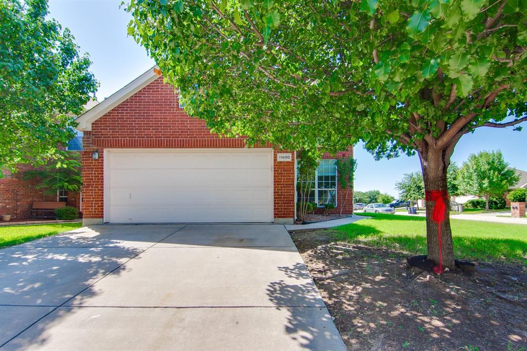 a front view of a house with a yard and a garage
