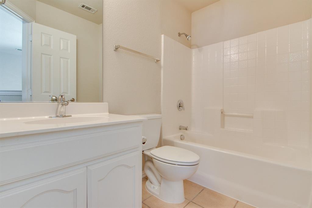 11800 Porcupine Drive Fort Worth, TX 76244 - Photo 11 of 12 a bathroom with a sink a toilet and shower