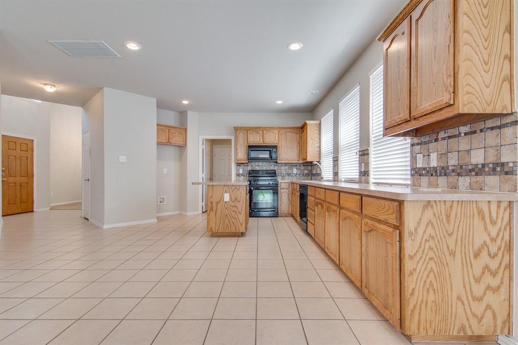 11800 Porcupine Drive Fort Worth, TX 76244 - Photo 6 of 12 a large kitchen with stainless steel appliances lots of counter space and cabinets