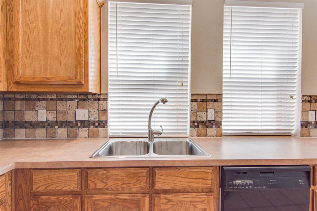 11800 Porcupine Drive Fort Worth, TX 76244 - Photo 7 of 12 a kitchen that has a sink and cabinets