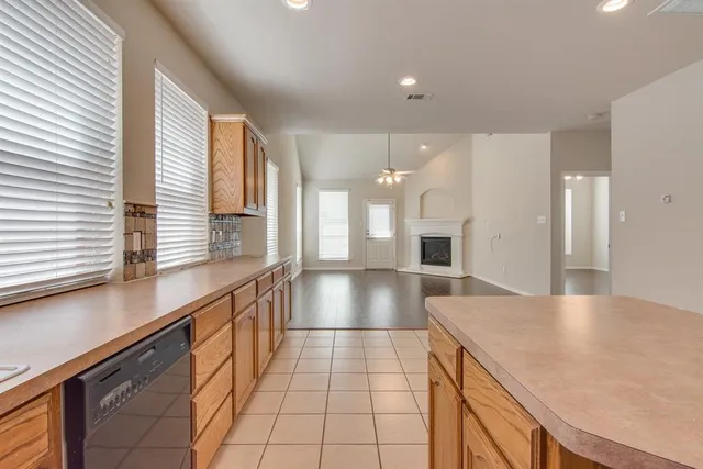 a view of a kitchen with kitchen island a large window a sink and living room view