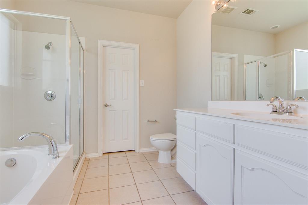 11800 Porcupine Drive Fort Worth, TX 76244 - Photo 9 of 12 a spacious bathroom with a granite countertop sink a toilet and shower