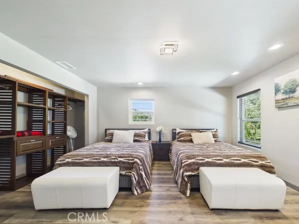 a bedroom with bed and wooden floor