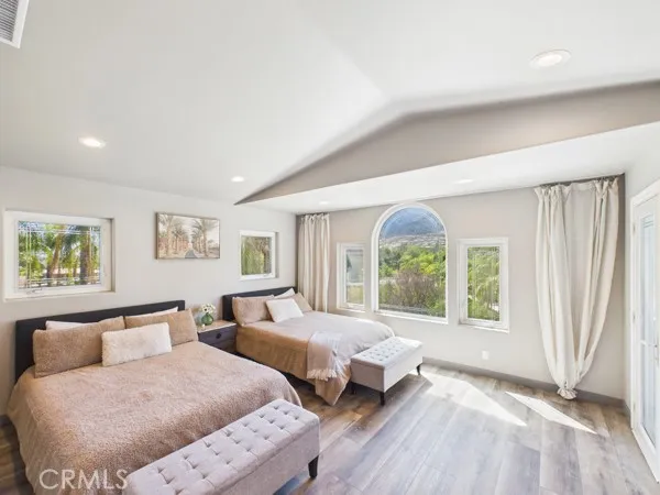 a spacious bedroom with two beds and a large window