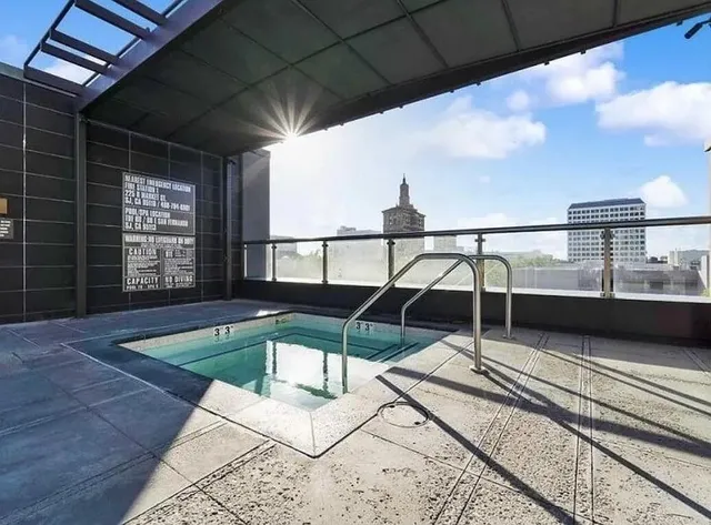 a living room with furniture a lamp and rug