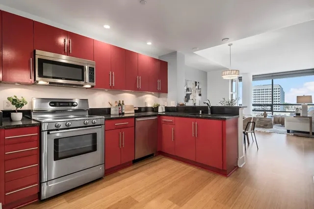 a kitchen with kitchen island granite countertop a sink stainless steel appliances and counter space