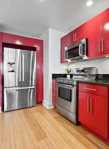 a dining room with furniture potted plants and wooden floor