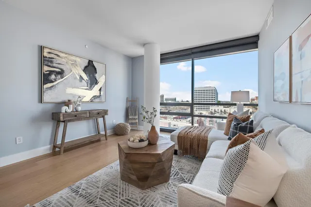 a living room with furniture and a potted plant