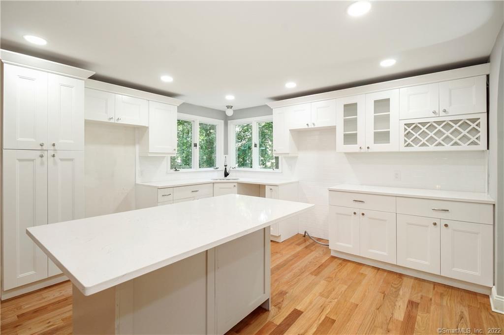 a kitchen with a sink a stove and cabinets