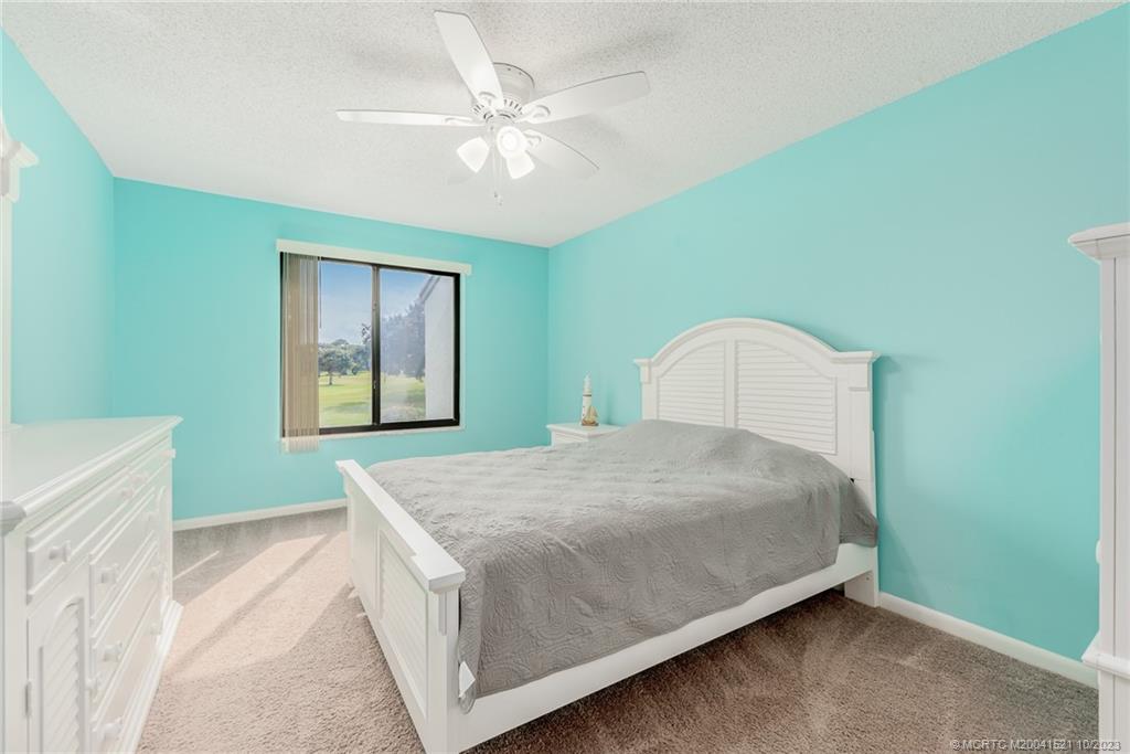 5433 Southeast Miles Grant Road, Unit 203 Stuart, FL 34997 - Photo 14 of 31 a bedroom with a bed and a window