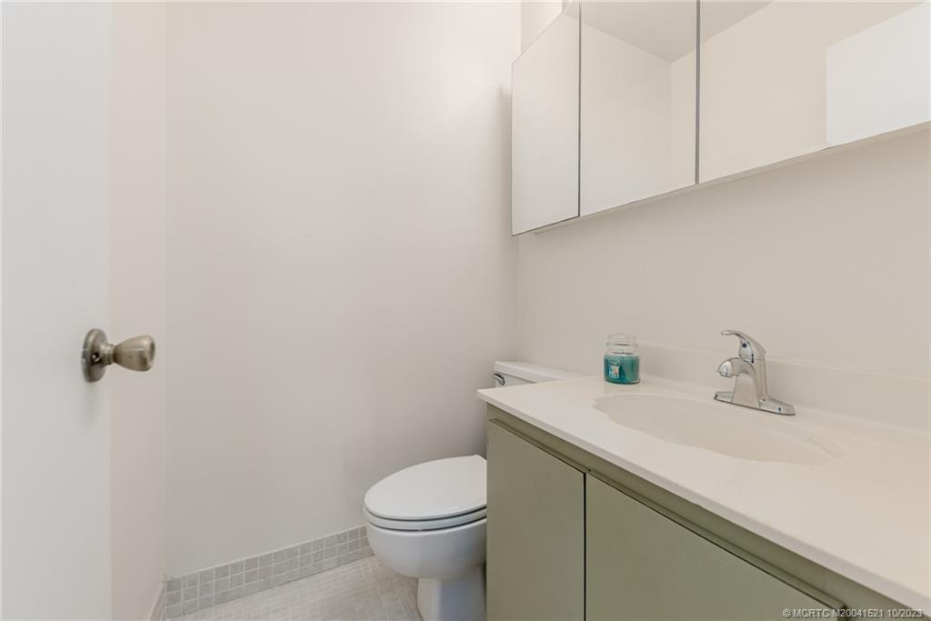 5433 Southeast Miles Grant Road, Unit 203 Stuart, FL 34997 - Photo 17 of 31 a view of bathroom with a sink a toilet and vanity