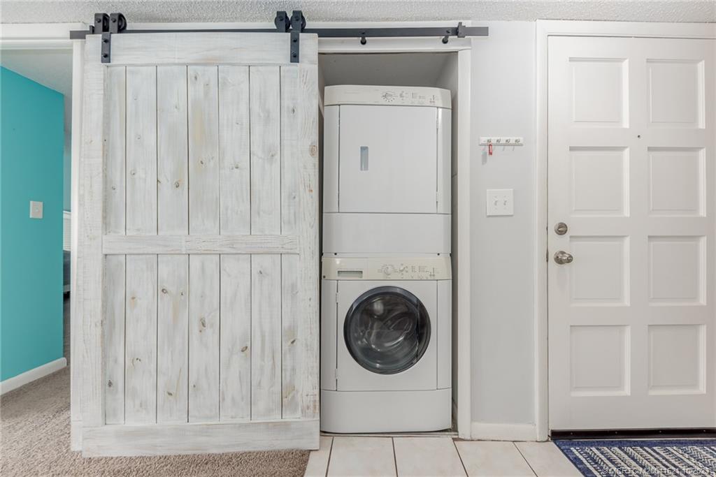 5433 Southeast Miles Grant Road, Unit 203 Stuart, FL 34997 - Photo 18 of 31 a utility room with dryer and washer