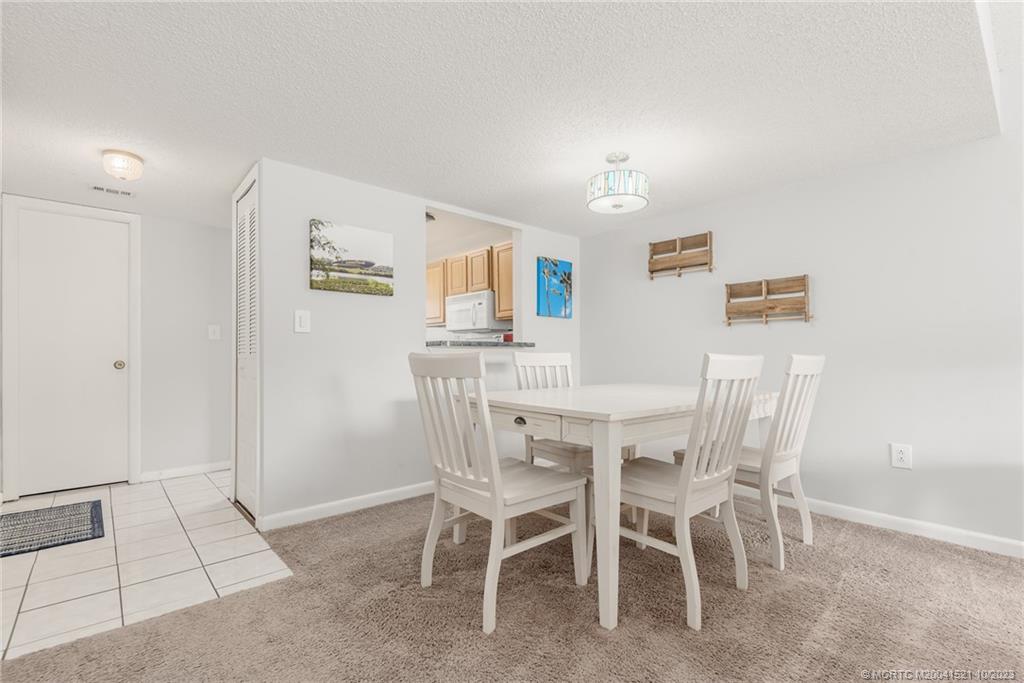 5433 Southeast Miles Grant Road, Unit 203 Stuart, FL 34997 - Photo 7 of 31 a dining room with furniture and window