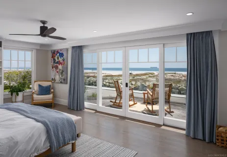 a bedroom with a large bed and a large window