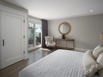 a bedroom with a bed and painting on the wall