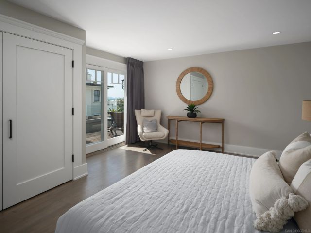 a bedroom with a bed and painting on the wall