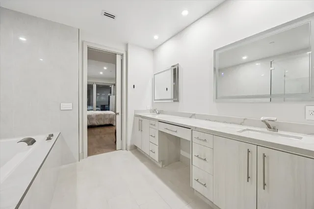 a spacious bathroom with a granite countertop sink mirror and