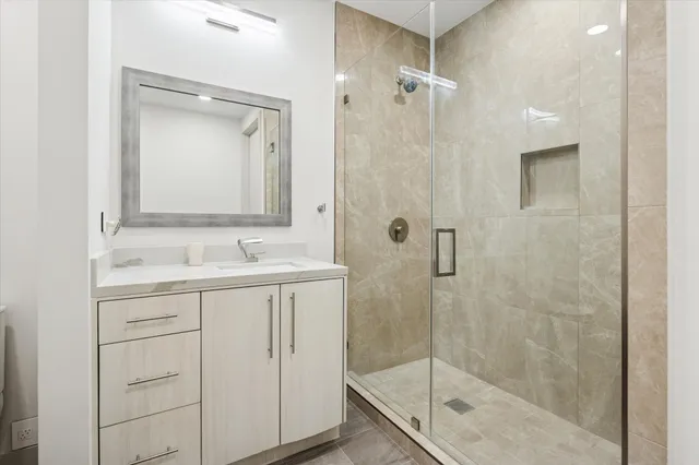a bathroom with a shower sink and mirror