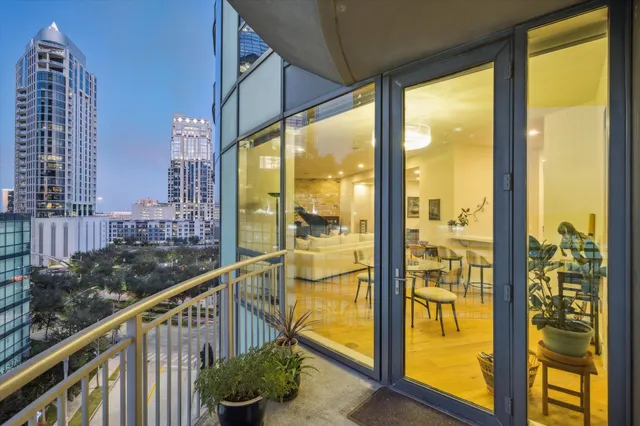 a view of balcony with floor to ceiling window and wooden floor