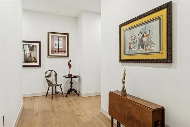 a living room with furniture and a book shelf