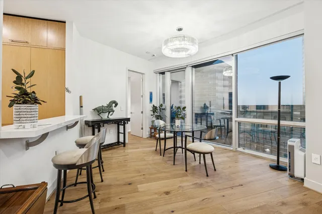 a living room with furniture a rug and a large window