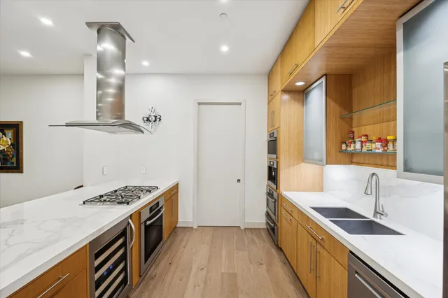 a kitchen with stainless steel appliances granite countertop a sink stove and refrigerator