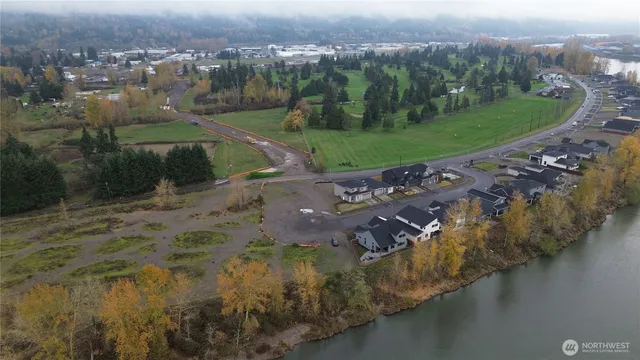an aerial view of residential house with outdoor space and trees
