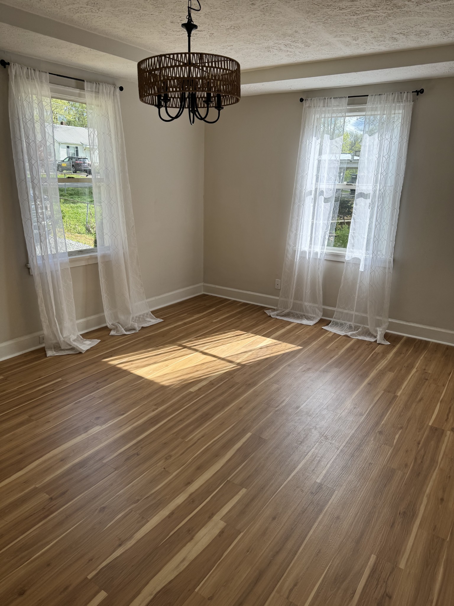 1210 Daniel Street Clarksville, TN 37040 - Photo 2 of 5 a view of an empty room with wooden floor and a window