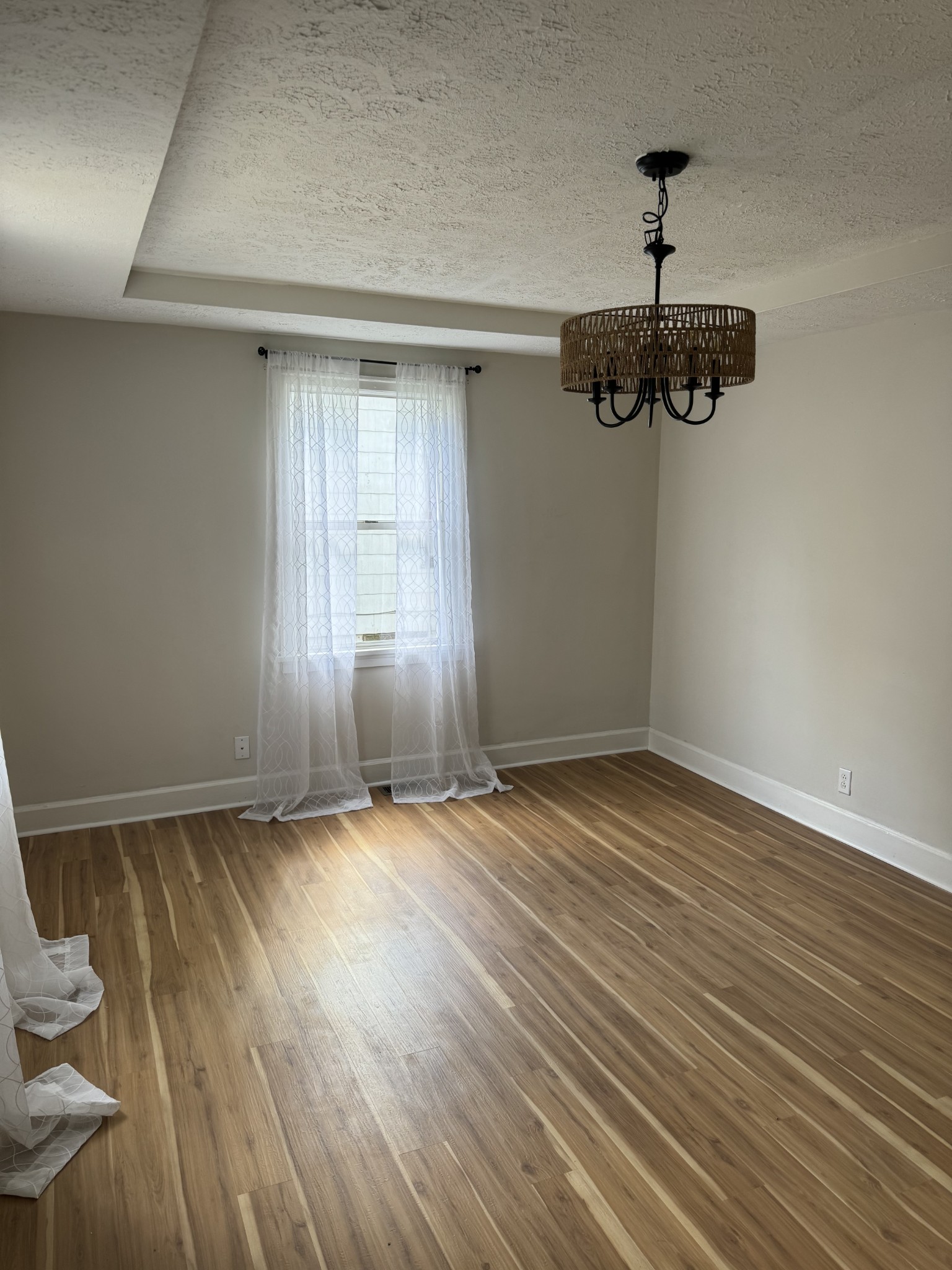 1210 Daniel Street Clarksville, TN 37040 - Photo 3 of 5 a view of an empty room with wooden floor and window