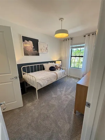 a bedroom with furniture and a window