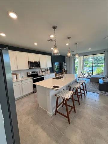 a large kitchen with a table and chairs