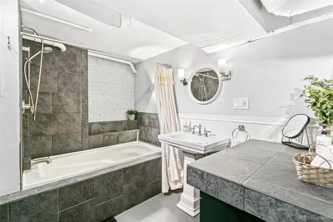 a kitchen with stainless steel appliances granite countertop a sink and a stove next to a large window