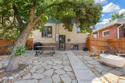 a view of a patio with couple of chairs and a fire pit