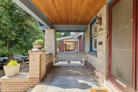 a view of a patio with table and chairs and wooden floor