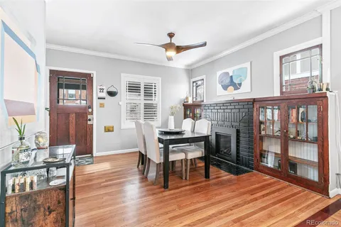 a living room with furniture a fireplace and a window