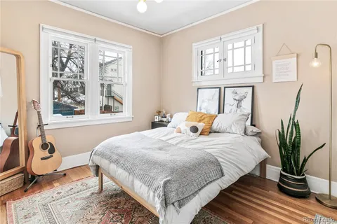 a bedroom with a bed and wooden floor