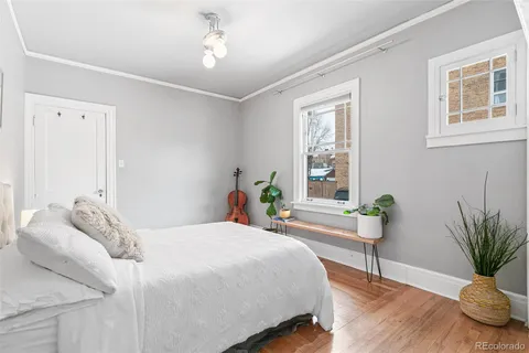 a bedroom with a bed and a potted plant
