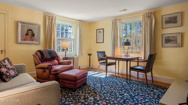 a view of a kitchen area with furniture and wooden floor