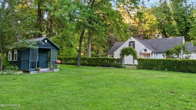 a view of an house with backyard space and balcony