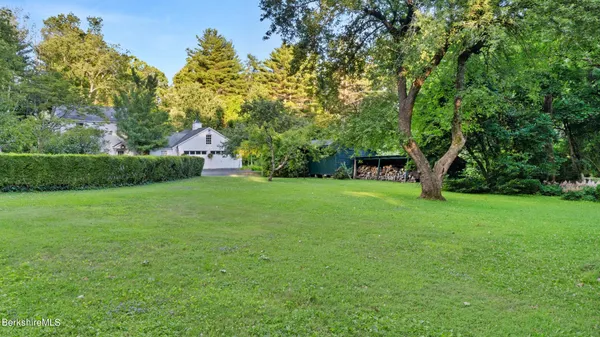 a view of a house with a tree in front of it