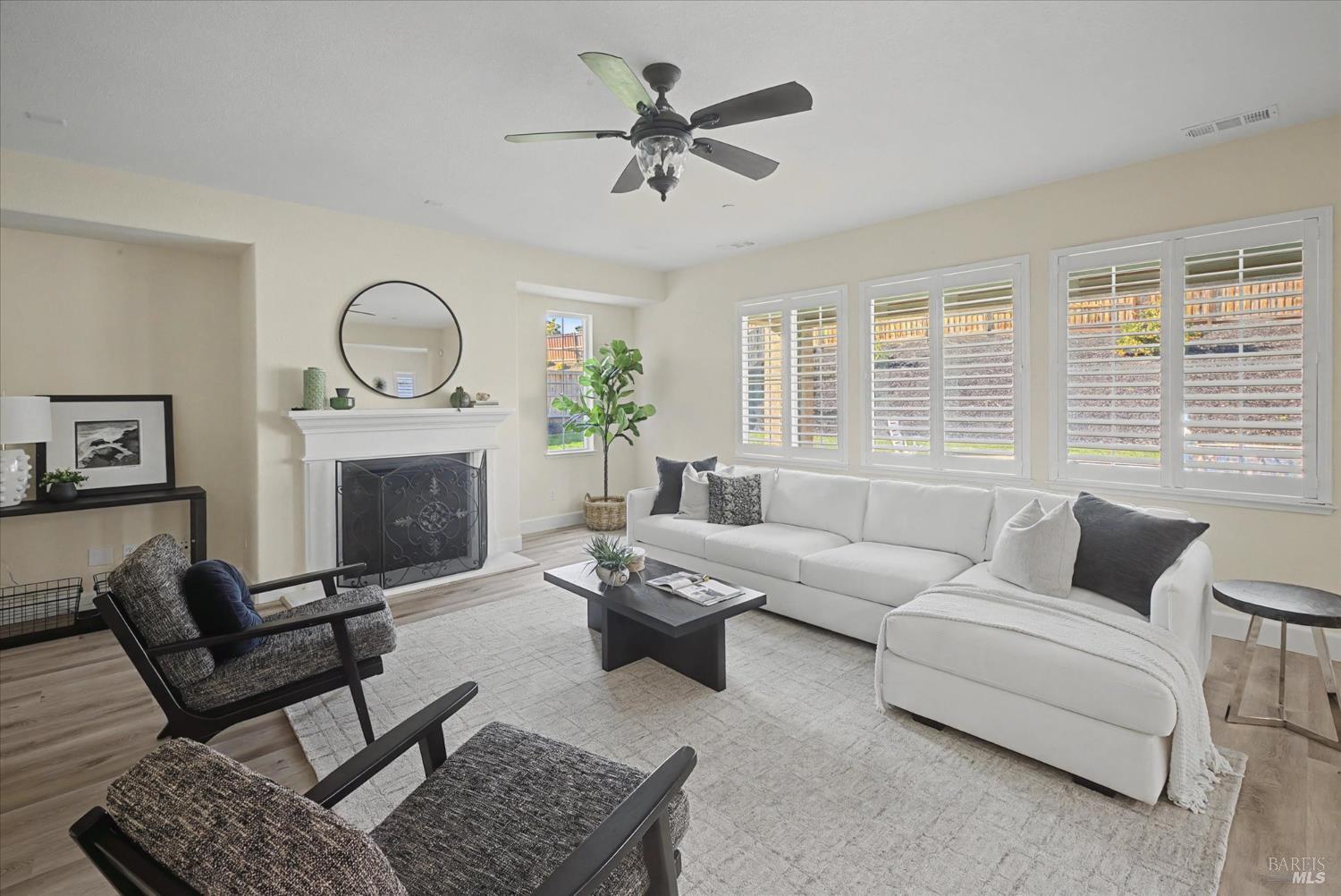 685 Elderberry Loop Vacaville, CA 95688 - Photo 17 of 73 a living room with furniture a fireplace and a large window