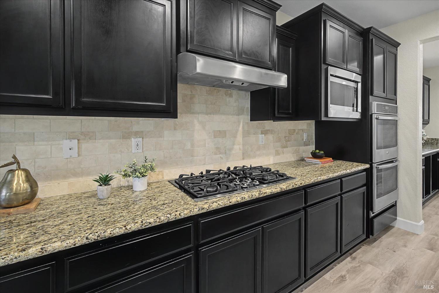 685 Elderberry Loop Vacaville, CA 95688 - Photo 24 of 73 a kitchen with granite countertop stainless steel appliances a sink stove and cabinets