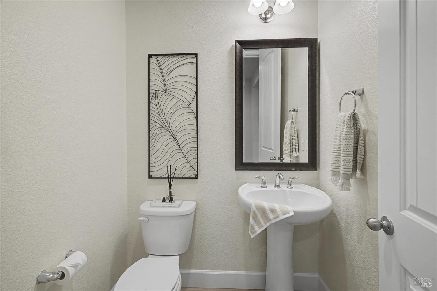 685 Elderberry Loop Vacaville, CA 95688 - Photo 37 of 73 a bathroom with a toilet sink and mirror
