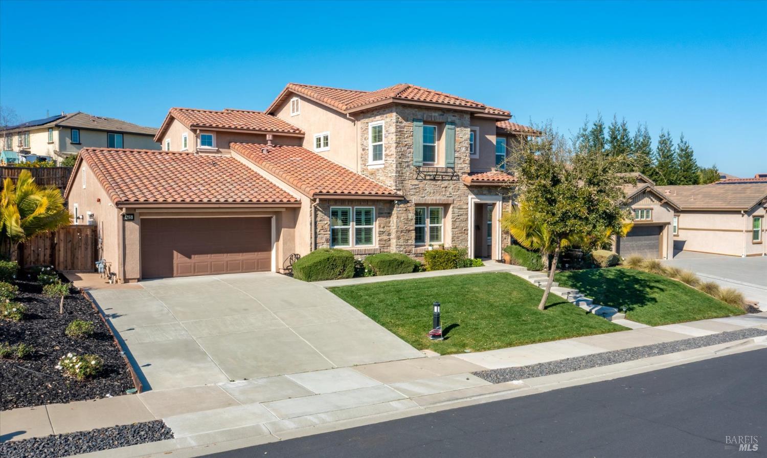 685 Elderberry Loop Vacaville, CA 95688 - Photo 4 of 73 a front view of a house with a yard and garage