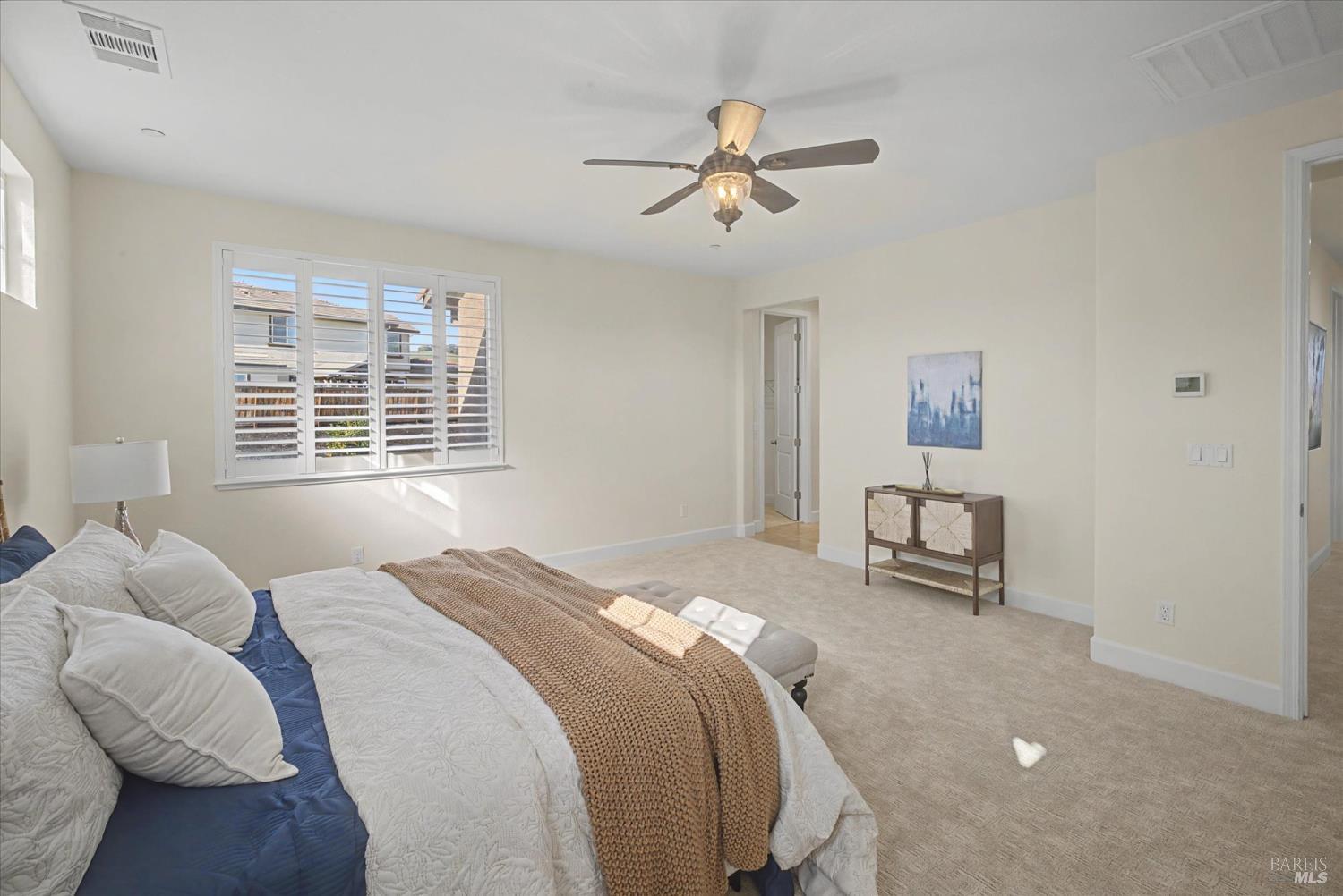 685 Elderberry Loop Vacaville, CA 95688 - Photo 44 of 73 a bedroom with a bed and a chandelier